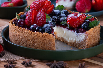 sweet pie with biscuit dough and butter and topped with jam and berries