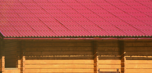 House with a roof made of solid metal sheets, shaped like an old tile