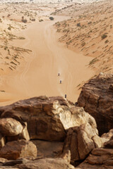 Fototapeta na wymiar Bikers riding in the White Desert of Mauritania near the Tifoujar pass.
