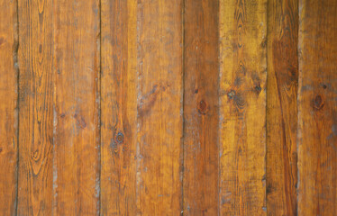 Texture of the old wooden wall from a number of scratched planks that are varnished