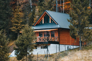 Wooden house in beautiful nature. Mountain style house. Pretty landscape with modern wooden house...