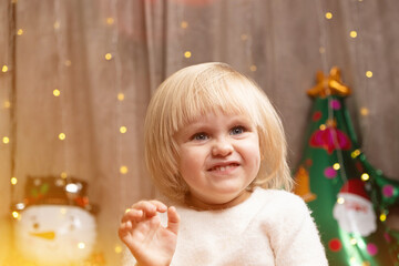 Portrait of two year old little Christmas blonde girl with blue eyes