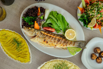 A picture from above of a table with dishes of fish and seafood appetizers