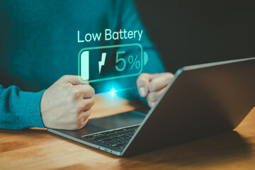 Laptop out of battery. Concept of Technology and daily life. Man is angry and frustrated when he learns that his laptop computer's battery is dead and did not bring the charger adapter.