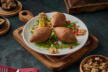 A plate of oriental fried kibbeh on a wooden floor