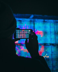 Une personne prend en photo l'oeuvre de la place louis pradel lors de la fête des lumières 2022 à Lyon, France - obrazy, fototapety, plakaty