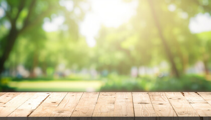 Empty wood table and defocused bokeh and blur background of garden trees with sunlight. product display template.