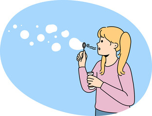 Happy girl blowing soap bubbles