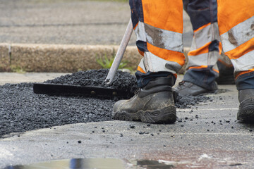 Repairing a broken road with new asphalt 
