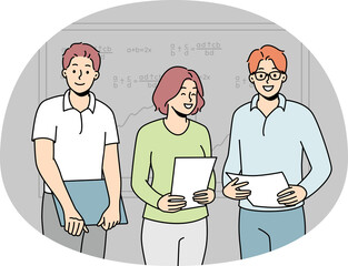 Smiling students make presentation near board