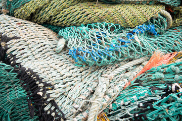 Fishing nets in a Breton harbor with many fishing boats 