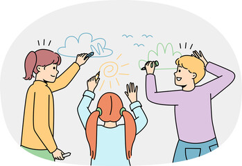 Happy children drawing on wall