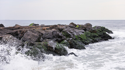 beach waves, a soothing symphony of nature's power and serenity, crashing on a sandy shore under a clear blue sky