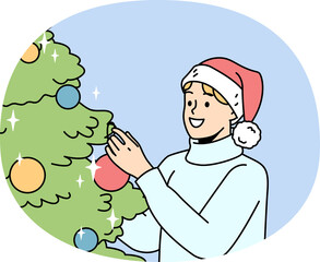 Smiling man decorate Christmas tree