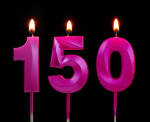 Burning pink birthday candles isolated on black background. Number 150.