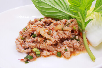 Minced pork larb, Thai food with vegetables Medium distance shot, 45 degree angle