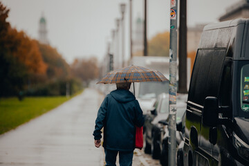 Walking in the Rain: Urban City Scene with Pedestrian and Umbrella