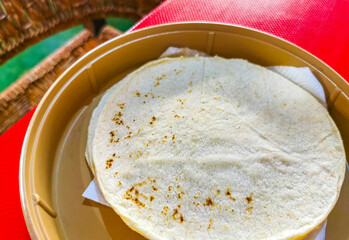 Tortillas in a bowl Plate on red table in Mexico.