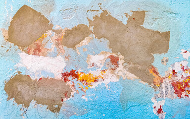 Old cracked blue painted wall with sloping sections in Mexico.