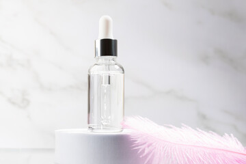 serum in a bottle with retinol for face with a dropper with a soft delicate feather, natural...