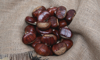 Chestnuts on a burlap sack.Close-up. Selective focus.Chestnuts on a burlap sack