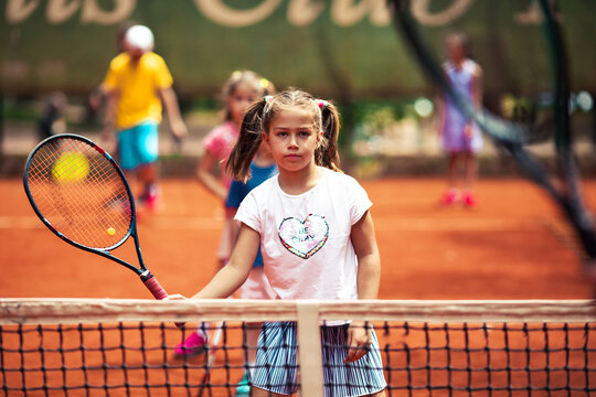 Young girl tennis player ready to hit forehand during practice