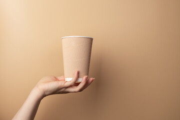 Hot tea in a takeaway cup, Hand with a cup of coffee