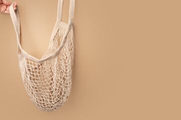 Obraz premium mesh bag in hand,eco friendly fruit and vegetables bag,copy space, responsible consumption
