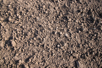 Brown crushed soil peat field abstract texture may be used as a  background wallpaper
