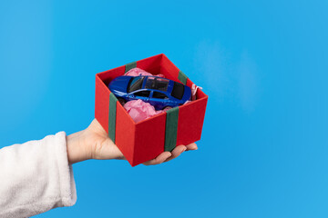 a car in a gift box, Christmas present, festive package, happy holiday
