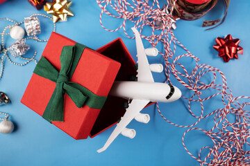 christmas gift travel, winter holidays, airplane tickets, booking hotels, plane in a present box