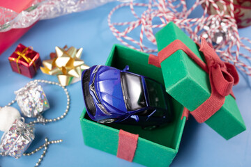gift car in a Christmas present box, buying a car, vehicle holiday sales