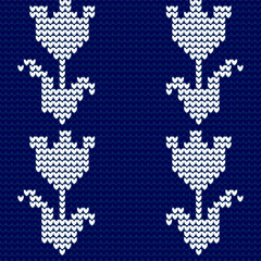Seamless knitted pattern with flowers. Vector illustration. Blue background.