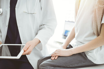 Doctor and child patient. The doctor is using tablet computer and is ready to examine the boy. The concept of ideal health in medicine