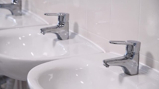 Close-up of row modern ceramic wash hand basins
