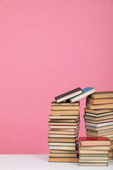 science education stack of books on pink background literacy training