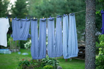 Hanging laundry on a rope in the garden.Dry clothes in the fresh air. Laundry in nature.