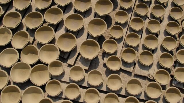 Indian potter making Diya (oil lamps) or earthen lamps for Diwali Festival with clay, Handwork craft. Pune, India.