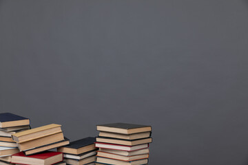 science education stack of books on grey background learning literacy