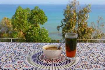 A cup of Moroccan mint tea with a sea view at Haffa Café