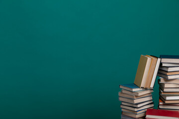 science education stack of books on a green background learning literacy