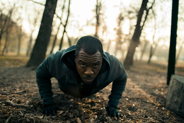 Young black man working out in a forest