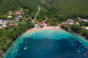 Aerial of Martinique's lush shoreline Anse Dufour aerial sunny day 