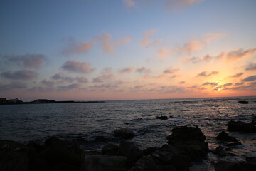 Sunset on the background of a rocky beach