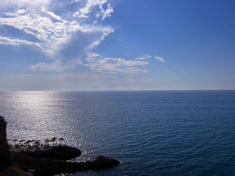 Beautiful sea and beach on rocky coast at summer evening.