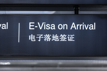 Electronic Visa on arrival signage concept at airport for tourists. Visa sign in English and Chinese in airport