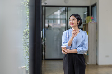 Business woman still thinking about work in a good mood during coffee break.