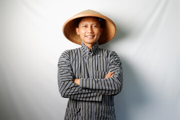 Asian farmer looking at camera with folded arm isolated on white background