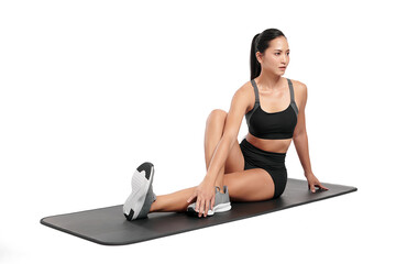 an asian woman is  working out  wearing the sport exercise suit with white background.