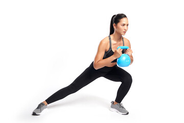 an asian woman is working out with kettlebell wearing the sport exercise suit with white...